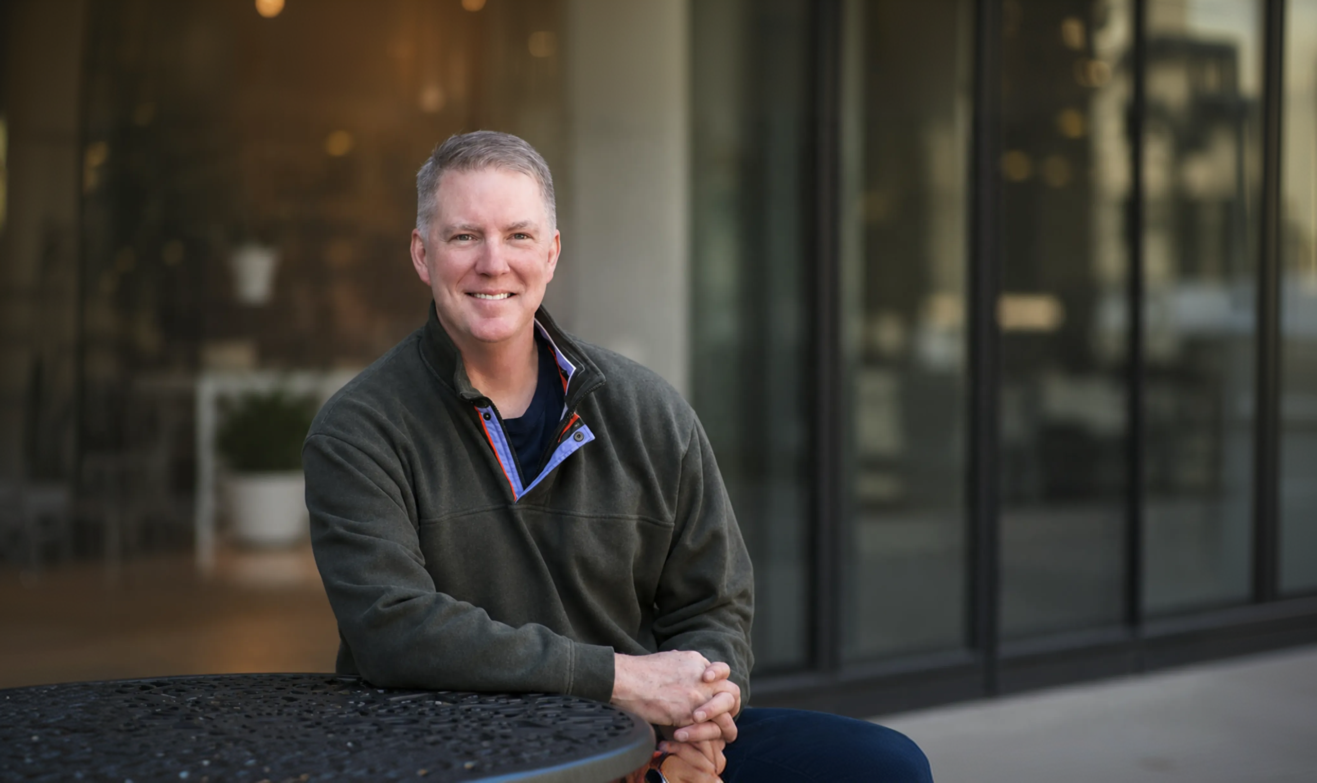 Dan Roberts seated outdoors.
